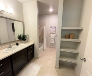 bathroom vanity, shower, shelving