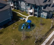drone image of playscape near apartment buildings
