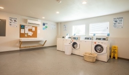 laundry rooms with four washers and folder counter
