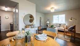 Dining and living room with table, chairs, arm chairs, floor lamp, and couch