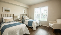 bedroom with two twin beds, armchair, window