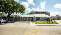 Outside image of Leasing Office and Community Learning Center with handicap parking, ramp, and crosswalk