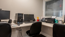 computer lab with two computers, printer, three chairs