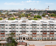 Village at Roosevelt exterior drone image with San Antonio skyline in the back