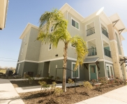 Greenwood apartment building with palm tree